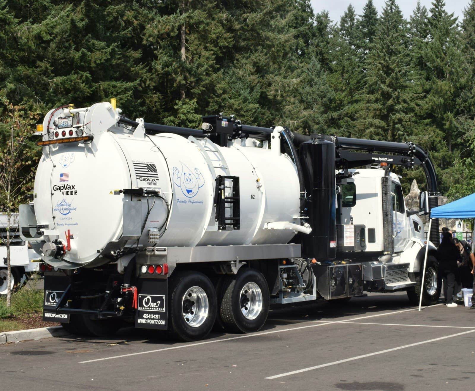 A vacuum tanker truck with its suction boom and hose reels stowed