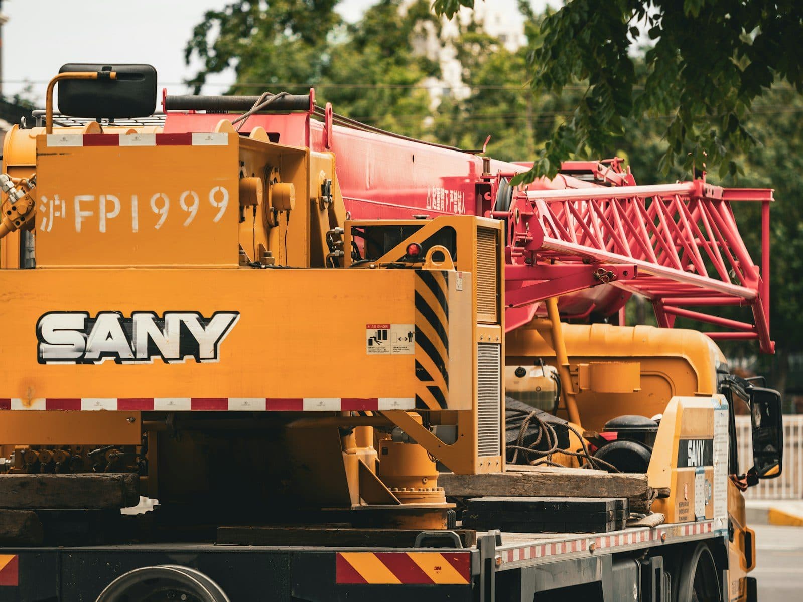 A mobile crane with its boom stowed, parked and ready to mobilise