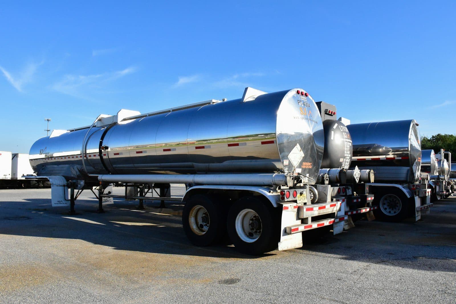 A polished stainless road tanker coupled and ready to move