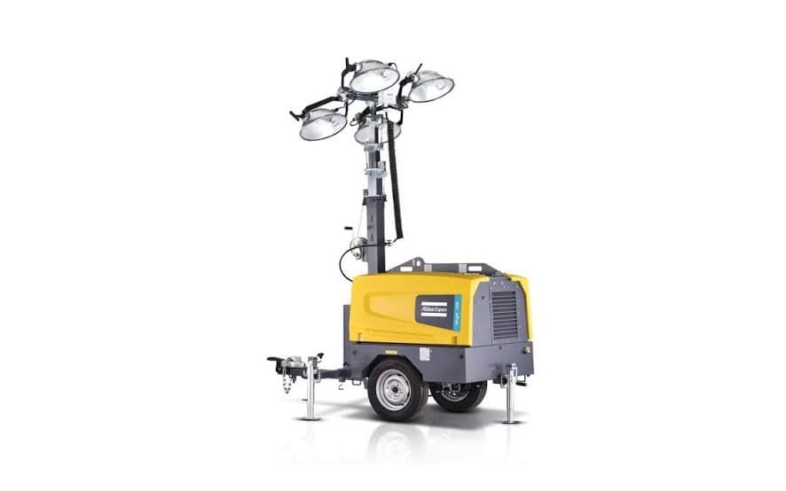 A trailer-mounted lighting tower with its mast raised and four lamp heads